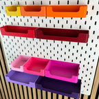 Detailaufnahme der Eingriffsöffnung an SKÅDIS Boxen in Rot, Pink und Violett